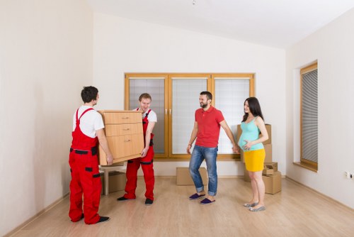 Moving furniture through a narrow stairwell in a Lambeth flat